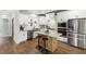 Bright, spacious kitchen featuring white cabinets, stainless steel appliances, and a central island with seating at 248 Daniel Ridge Rd, Wendell, NC 27591
