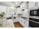 Modern kitchen design with white cabinets, stainless steel appliances, and marble countertops at 248 Daniel Ridge Rd, Wendell, NC 27591