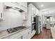 Gourmet kitchen with white cabinets, stainless steel appliances, and gas range at 248 Daniel Ridge Rd, Wendell, NC 27591