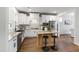 Well-lit kitchen featuring white cabinets, stainless steel appliances, and a kitchen island with seating at 248 Daniel Ridge Rd, Wendell, NC 27591