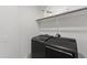 Modern laundry room with new washer and dryer and shelving at 248 Daniel Ridge Rd, Wendell, NC 27591