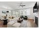 Spacious living room with modern decor, fireplace, and seamless flow to the dining area at 248 Daniel Ridge Rd, Wendell, NC 27591
