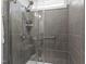 This shower features gray tile, glass door and dual shower heads at 248 Daniel Ridge Rd, Wendell, NC 27591