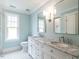Bathroom featuring tile flooring, a double sink vanity, and a large mirror at 2637 Sidford Aly, Raleigh, NC 27608