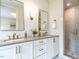 Bathroom with double vanity, brass fixtures, and tiled shower at 2637 Sidford Aly, Raleigh, NC 27608
