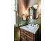 Elegant powder room with custom vanity, marble countertop, and decorative mirror at 2637 Sidford Aly, Raleigh, NC 27608