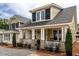 Inviting home with a charming front porch, stylish columns, and well-manicured landscaping enhancing its curb appeal at 2637 Sidford Aly, Raleigh, NC 27608