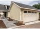 Attached two-car garage with an automatic garage door and adjacent patio at 2637 Sidford Aly, Raleigh, NC 27608