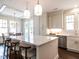 Bright kitchen with island seating, stainless appliances, white cabinets, and view of the dining area at 2637 Sidford Aly, Raleigh, NC 27608
