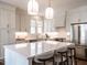 Elegant kitchen with large island, bar seating, stainless appliances, and lots of white cabinetry at 2637 Sidford Aly, Raleigh, NC 27608
