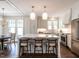 Stylish kitchen with island and bar stool seating, stainless steel appliances, and view of the dining area at 2637 Sidford Aly, Raleigh, NC 27608