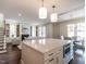 Spacious, modern kitchen with large island, stainless steel appliances, and open layout to the dining and living areas at 2637 Sidford Aly, Raleigh, NC 27608