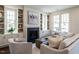 Stylish living area featuring a fireplace with built-in shelving, complemented by comfortable seating and natural light at 2637 Sidford Aly, Raleigh, NC 27608