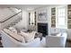 Inviting living room with a cozy fireplace and staircase, perfect for relaxing or entertaining guests in style at 2637 Sidford Aly, Raleigh, NC 27608
