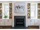 Elegant fireplace with built-in shelves, complemented by natural light from nearby windows, creating a cozy atmosphere at 2637 Sidford Aly, Raleigh, NC 27608