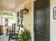 Inviting porch featuring rocking chairs, stylish lighting, and a freshly painted door for a charming entrance at 2637 Sidford Aly, Raleigh, NC 27608