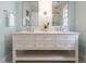 Bathroom featuring double sinks, a marble countertop, and modern fixtures in a stylish setting at 2641 Sidford Aly, Raleigh, NC 27608