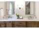 Bathroom featuring double vanity with light countertop, modern fixtures, and dual mirrors at 2641 Sidford Aly, Raleigh, NC 27608