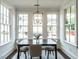 Bright dining room featuring a modern chandelier, white trim, and large windows offering ample natural light at 2641 Sidford Aly, Raleigh, NC 27608