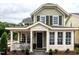 Charming home featuring a welcoming front porch, a black front door and manicured landscaping, creating a cozy curb appeal at 2641 Sidford Aly, Raleigh, NC 27608