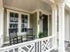 Charming front porch featuring decorative railings, seating, and a dark-stained front door at 2641 Sidford Aly, Raleigh, NC 27608