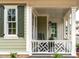 Charming front porch featuring decorative railings and seating, blending indoor comfort with outdoor allure at 2641 Sidford Aly, Raleigh, NC 27608