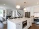 Open-concept kitchen featuring a large center island and stainless steel appliances, connected to living space at 2641 Sidford Aly, Raleigh, NC 27608