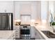 Close-up of kitchen with stainless steel appliances, quartz countertops, and custom cabinetry at 2641 Sidford Aly, Raleigh, NC 27608