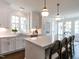 Well-lit kitchen with white cabinets, a spacious island, and modern appliances, great for cooking at 2641 Sidford Aly, Raleigh, NC 27608