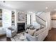 Bright living room with fireplace, custom built-ins, and stylish decor and staircase at 2641 Sidford Aly, Raleigh, NC 27608