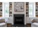 Living room with a fireplace flanked by built-in shelving, creating a cozy focal point at 2641 Sidford Aly, Raleigh, NC 27608