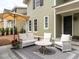 Inviting outdoor patio area with stylish furniture, an umbrella, and a neatly landscaped yard at 2641 Sidford Aly, Raleigh, NC 27608