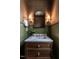 Elegant powder room featuring a custom vanity, designer mirror, and stylish sconces at 2641 Sidford Aly, Raleigh, NC 27608