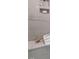 Close up of tiled shower with built-in shelving holding neatly stacked towels and decorative items at 2641 Sidford Aly, Raleigh, NC 27608