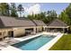 Backyard with large pool, lounge area, patio dining, and modern architectural design at 295 Lystra Preserve Dr, Chapel Hill, NC 27517