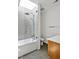 Modern bathroom with a skylight, glass shower door, gray tile, and a white vanity at 295 Lystra Preserve Dr, Chapel Hill, NC 27517