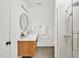 Bathroom featuring a modern vanity with double sinks and a glass-enclosed shower with tiled walls at 295 Lystra Preserve Dr, Chapel Hill, NC 27517