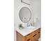 Modern bathroom featuring a round mirror, sleek fixtures, and floating wood grain vanity at 295 Lystra Preserve Dr, Chapel Hill, NC 27517