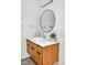 Modern bathroom featuring a round mirror, sleek fixtures, and floating wood grain vanity at 295 Lystra Preserve Dr, Chapel Hill, NC 27517
