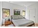Cozy bedroom with large windows and a comfortable bed with a wood frame and neutral color palette at 295 Lystra Preserve Dr, Chapel Hill, NC 27517