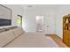 Bright bedroom featuring light wood floors, a walk-in shower and a neutral color palette at 295 Lystra Preserve Dr, Chapel Hill, NC 27517
