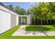 Modern home featuring a contemporary entrance with an artificial lawn, pavers and lush trees at 295 Lystra Preserve Dr, Chapel Hill, NC 27517