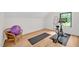Bright exercise room with wood floors and modern equipment like a spin bike at 295 Lystra Preserve Dr, Chapel Hill, NC 27517