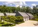 Exterior view of home featuring an oversized driveway, three-car garage, and landscaped lawn at 295 Lystra Preserve Dr, Chapel Hill, NC 27517