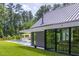 Modern home with large glass windows overlooking a well-maintained lawn and pool at 295 Lystra Preserve Dr, Chapel Hill, NC 27517