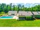 Aerial view of home featuring an in-ground pool, backyard and beautifully landscaped property at 295 Lystra Preserve Dr, Chapel Hill, NC 27517