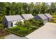 Aerial view of home featuring an oversized driveway, three-car garage, and fenced backyard at 295 Lystra Preserve Dr, Chapel Hill, NC 27517