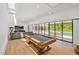 Open concept game room featuring a modern living room, wooden pool table, and seamless transition to the outdoors at 295 Lystra Preserve Dr, Chapel Hill, NC 27517