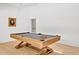 Bright game room with a wooden pool table on hardwood floors with an adjacent hallway at 295 Lystra Preserve Dr, Chapel Hill, NC 27517