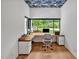Bright home office with custom built-in desk, hardwood floors, and large picture window at 295 Lystra Preserve Dr, Chapel Hill, NC 27517